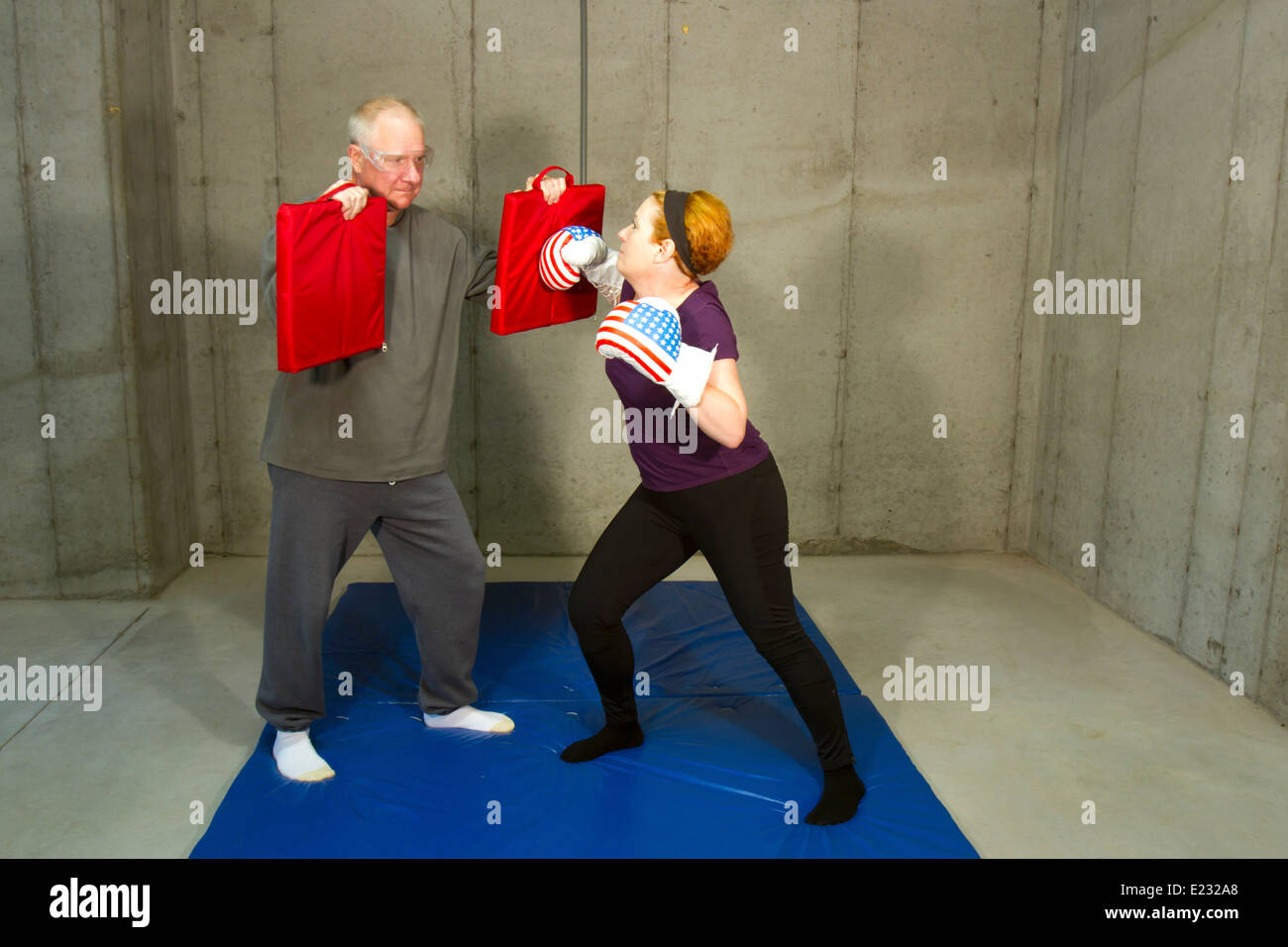 Mature women learning how to box against a man during a self defense class  Stock Photo - Alamy