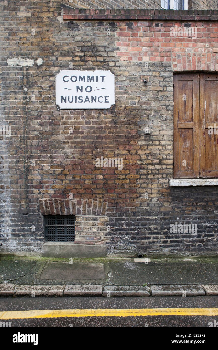 An old street sign saying 'commit no nuisance' in the backstreets of Borough, South London Stock Photo