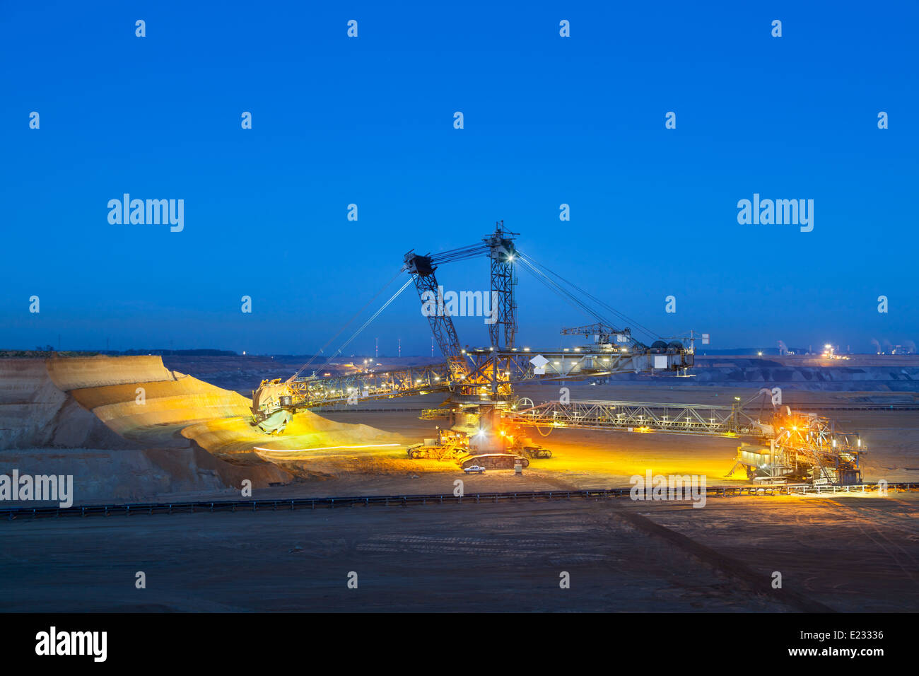 A giant Bucket Wheel Excavator at work in a lignite pit mine at night Stock Photo