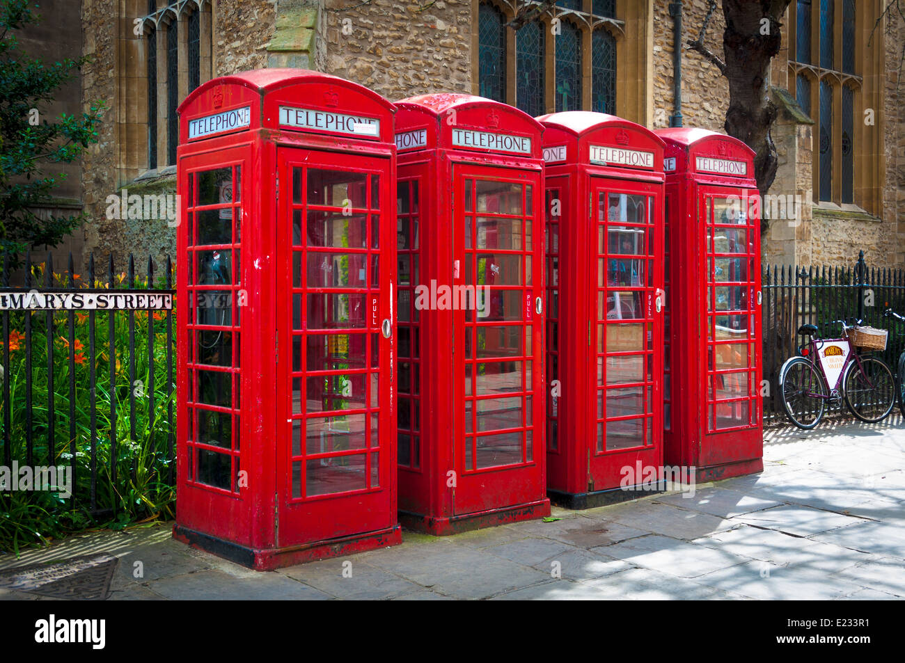 Row of red British telecom telephone boxes, England, UK Stock Photo