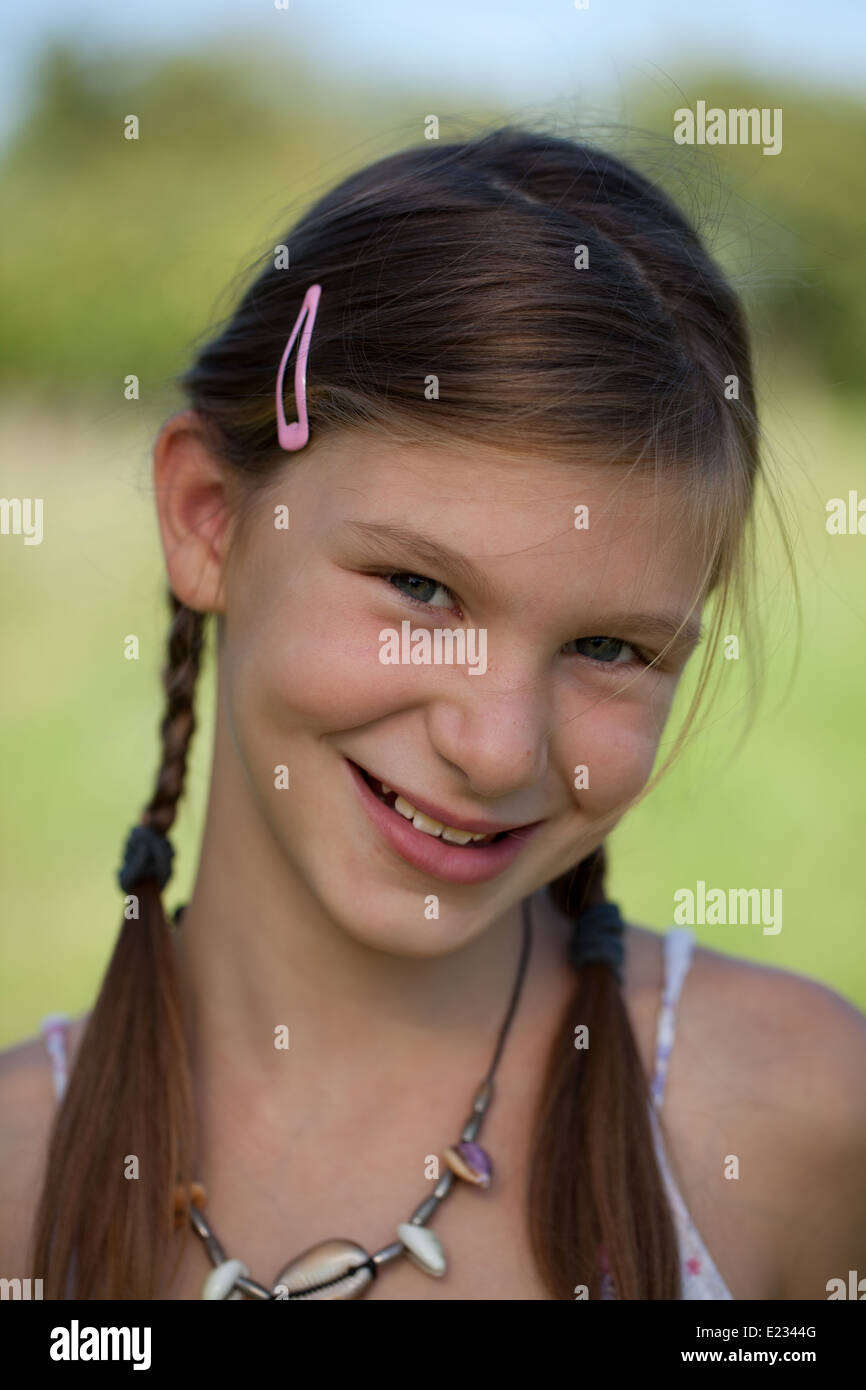 Portrait of a happy smiling young girl with braids Stock Photo - Alamy