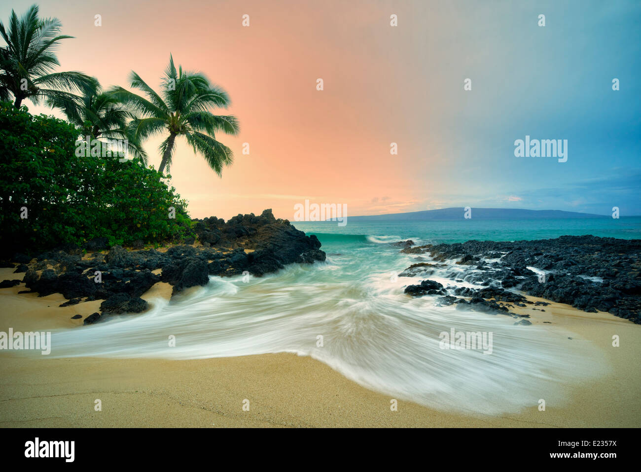 Secluded beach with palm trees and sunrise. Maui, Hawaii Stock Photo