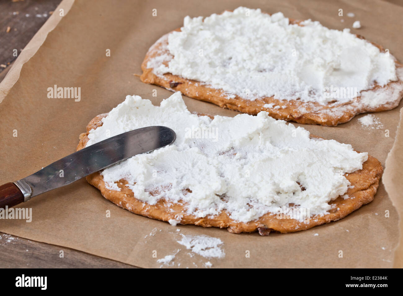 Pizza bases with ricotta cheese ready for baking Stock Photo Alamy