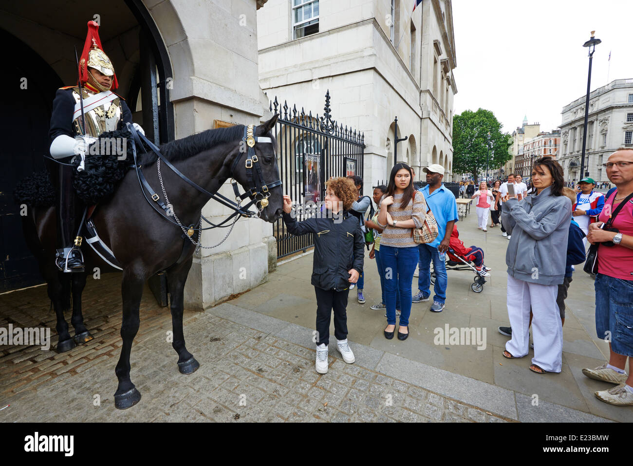 Crowds taking photographs of a guard at Horse Guards Parade Whitehall London UK Stock Photo