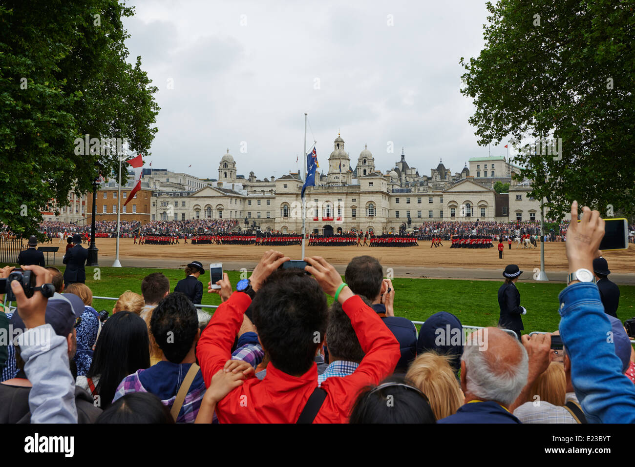 Crowds gather to watch and take photographs at  the Trooping of the colour from Horse Guards Parade London UK Stock Photo