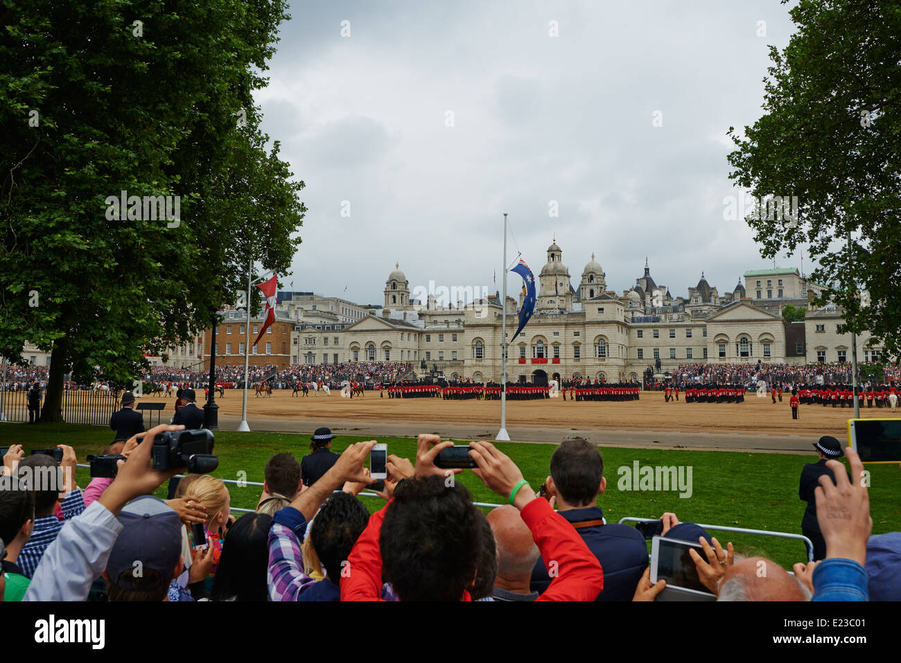 Crowds gather to watch and take photographs at  the Trooping of the colour from Horse Guards Parade London UK Stock Photo
