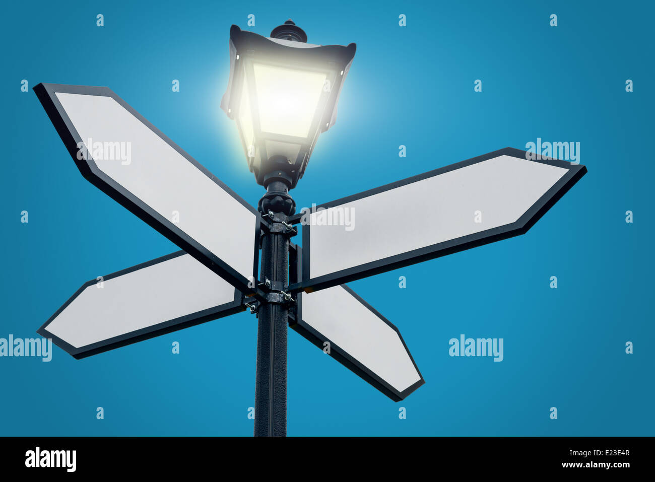 Lamppost with directional arrows Stock Photo