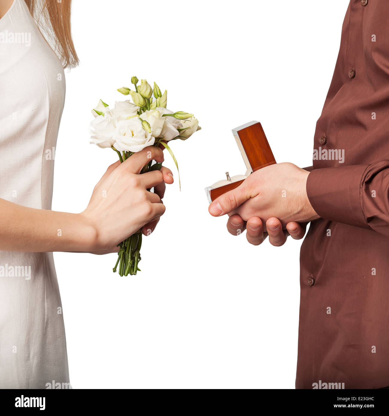 Wedding couple holding ring box and a bouquet of flowers Stock Photo