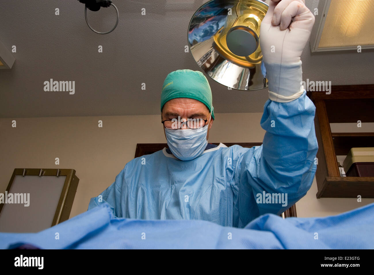 Surgeon in scrubs in surgery in operating room Stock Photo