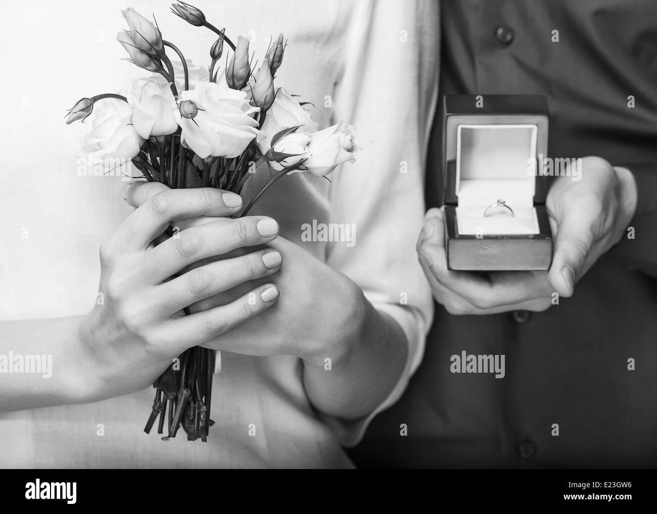Wedding couple holding ring box and a bouquet of flowers Stock Photo