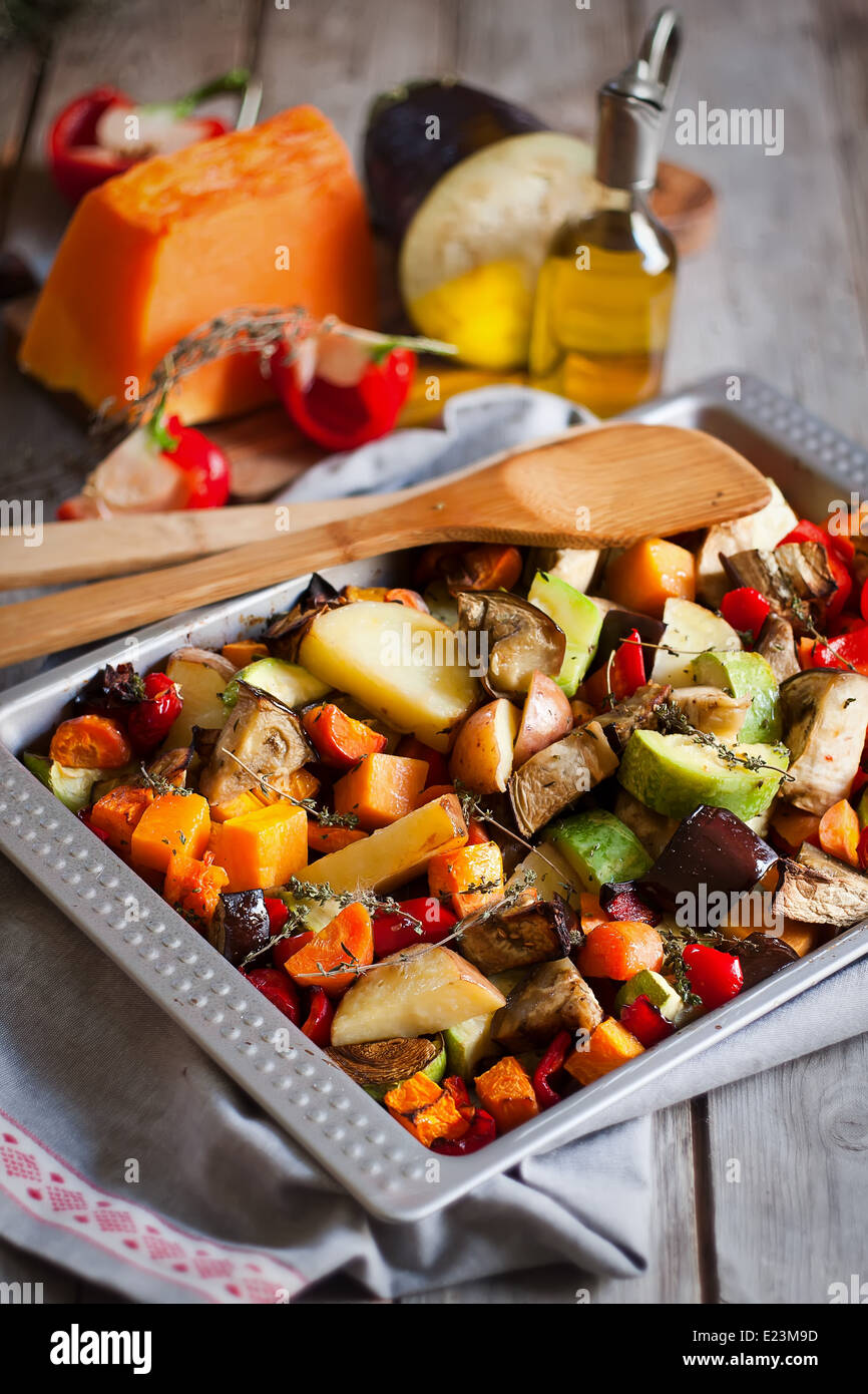 Mixed roasted vegetables with thyme in a tray. Selective focus. Stock Photo