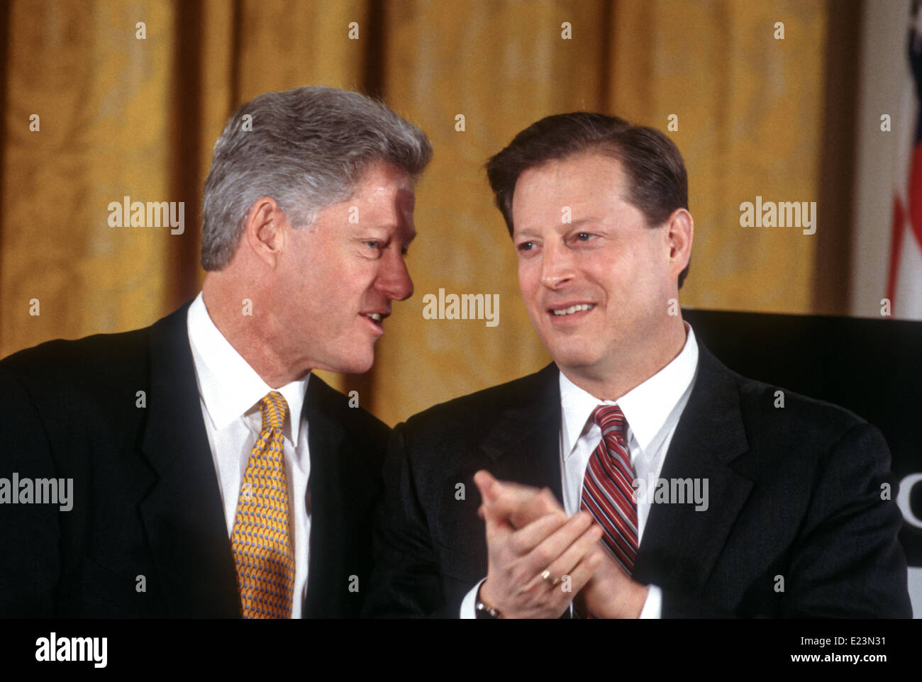 US President Bill Clinton and Vice President Al Gore talk as they unveil  the first balanced federal budget in the East Room of the White House  February 2, 1999 in Washington, DC