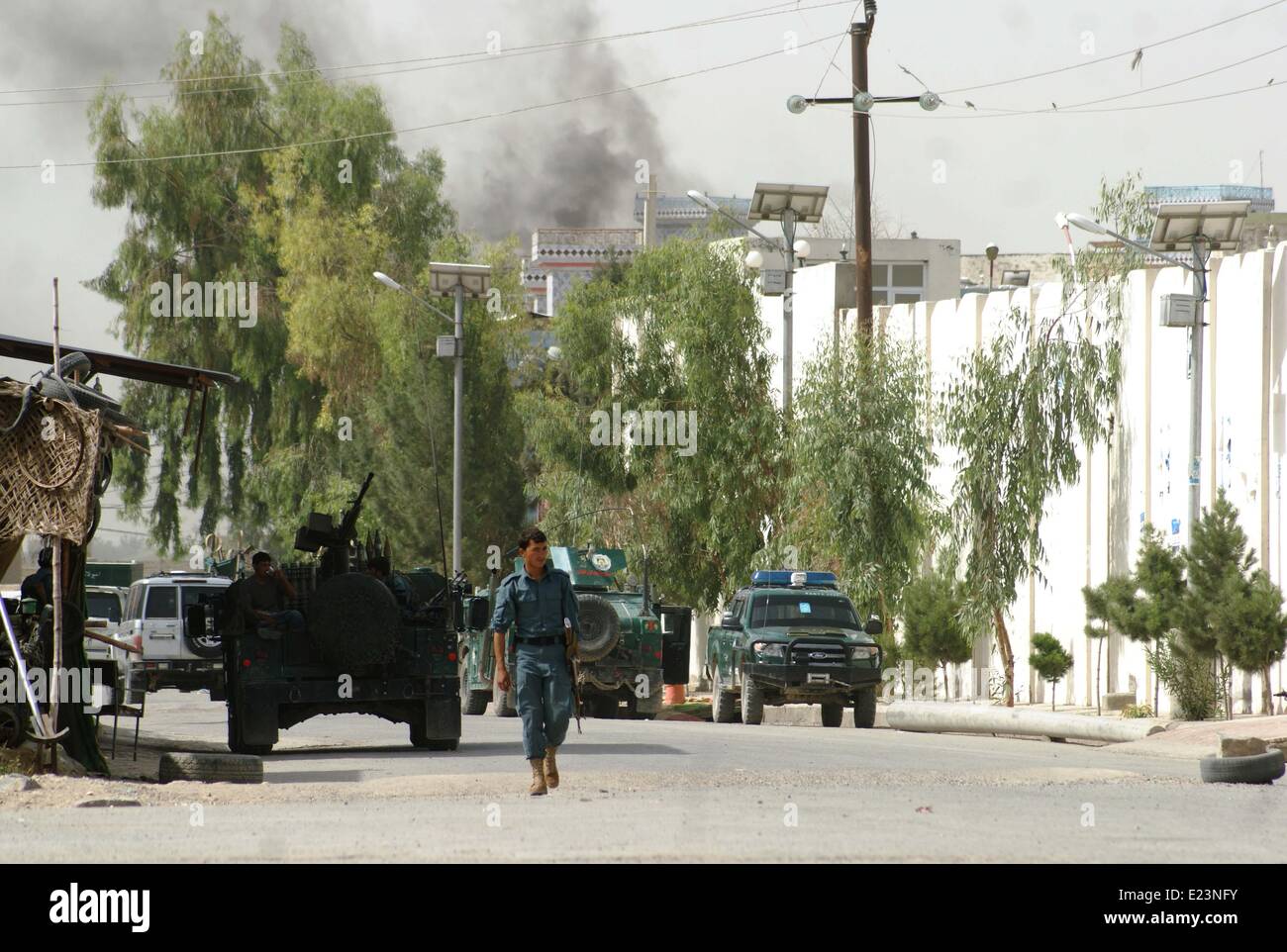 Kandahar. 15th June, 2014. Afghan policemen check the site of the attack in southern Afghanistan's Kandahar, on June 15, 2014. Four insurgents and two policemen were killed in an exchange of fire in southern Kandahar province on Sunday, police said. Credit:  Arghand/Xinhua/Alamy Live News Stock Photo