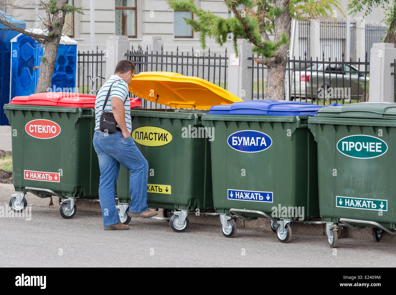 Man throws trash in the dumpster with inscription on russian " Plastic Stock Photo Alamy