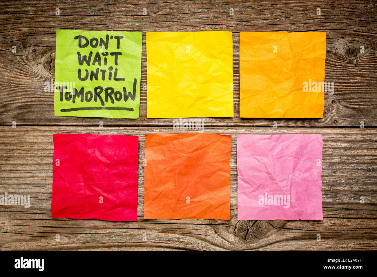 do not wait until tomorrow - motivational reminder - handwriting on sticky note against grained wood Stock Photo