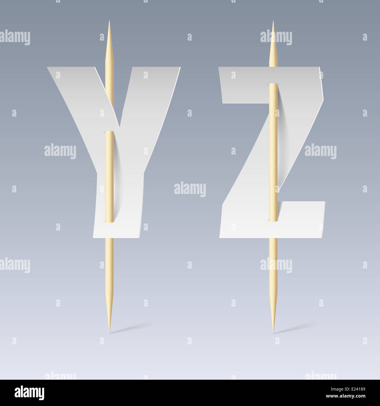 White paper cut font on toothpicks on grey background. Y and Z letters ...