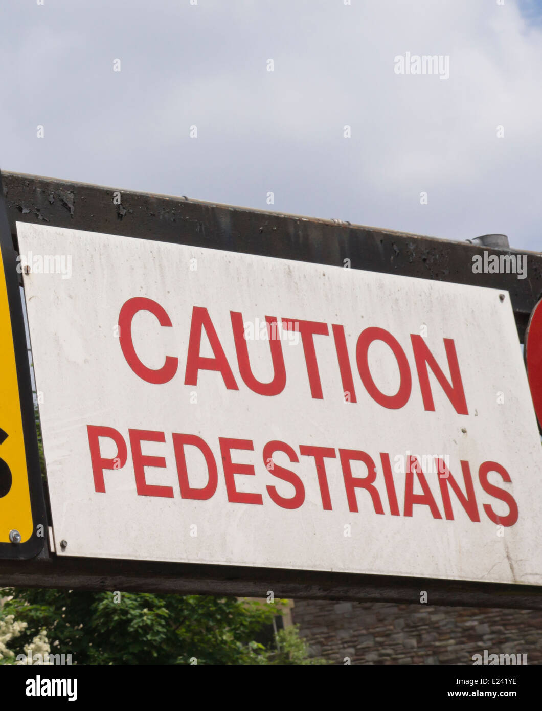 White sign, Caution pedestrians Stock Photo