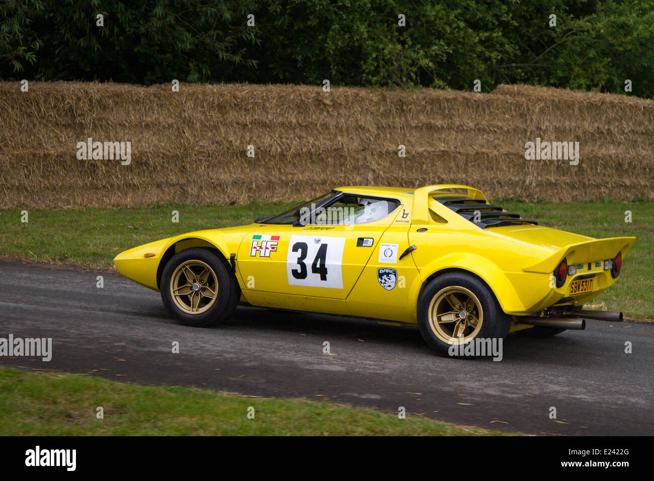 Yellow 1975 70s seventies Lancia Stratos sports car No.34 driven by Andrew Ferguson at the Cholmondeley Pageant of Power.  The action is at the 1.2-mile track within the park grounds of Cholmondeley Castle where over 120 cars compete, spanning seven decades of motorsports. Stock Photo