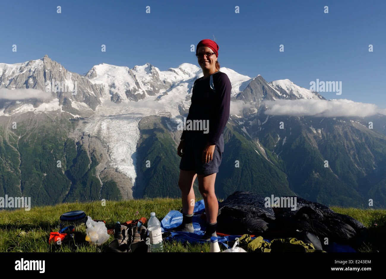 A lady at a wild camp on le Brevent  in the French Alps with the Mont Blanc massif beyond Stock Photo