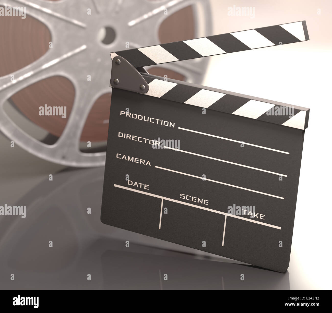 Clapboard on a reflective table with a roll of film on background. Stock Photo