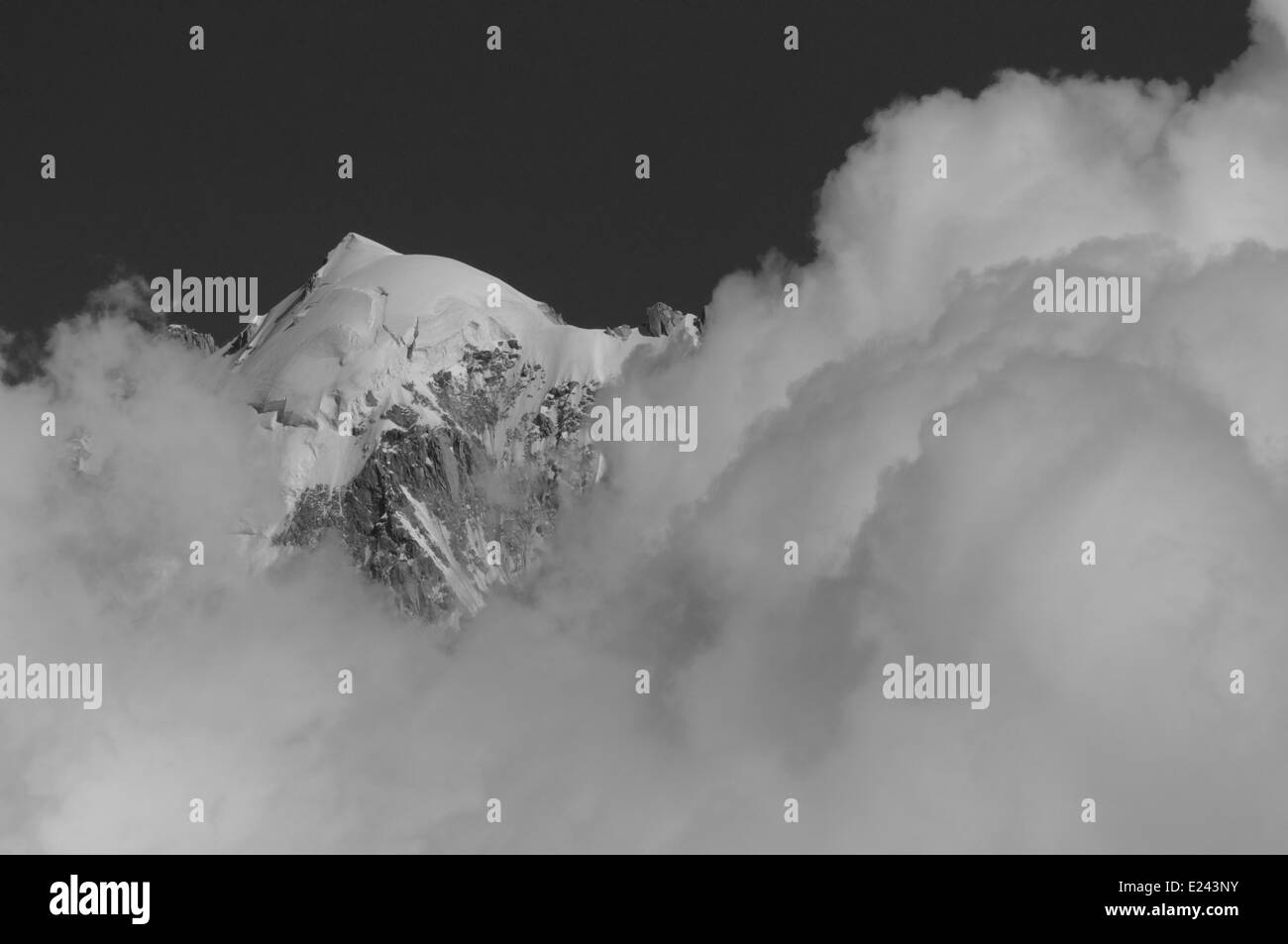 A mountain top and clouds - the Aiguille Verte in Chamonix, France Stock Photo