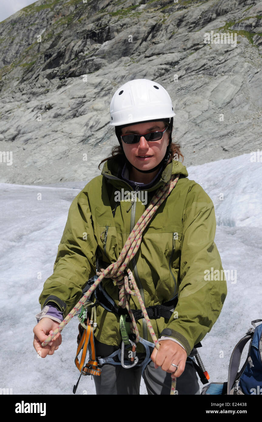 A lady mountaineer practicing tying knots in a climbing rope on an