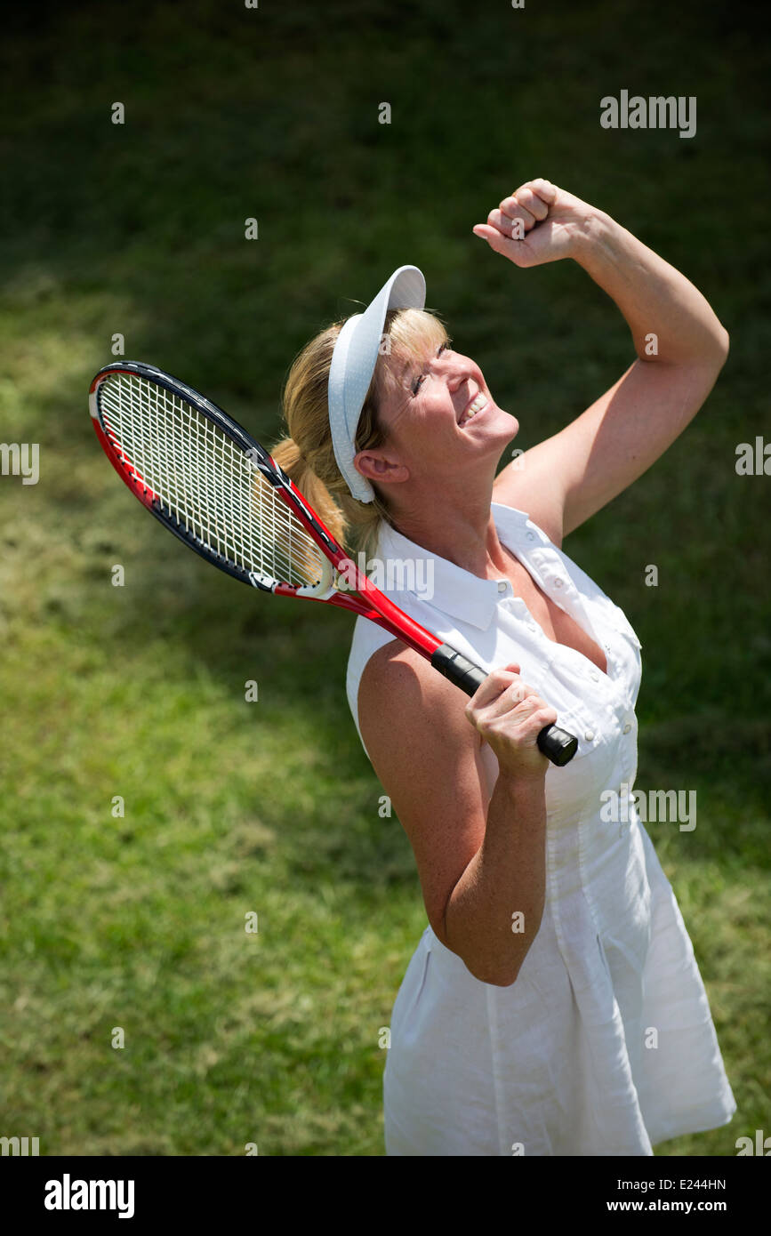 Jubilant female tennis player Stock Photo