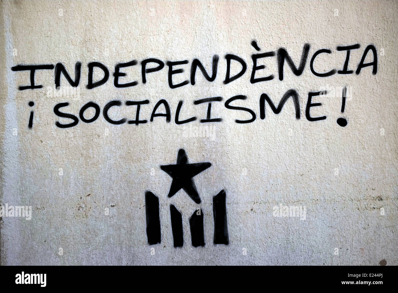 The Catalan flag with a written message that reads 'Independence Socialism' in Catalonia an autonomous community of Spain Stock Photo