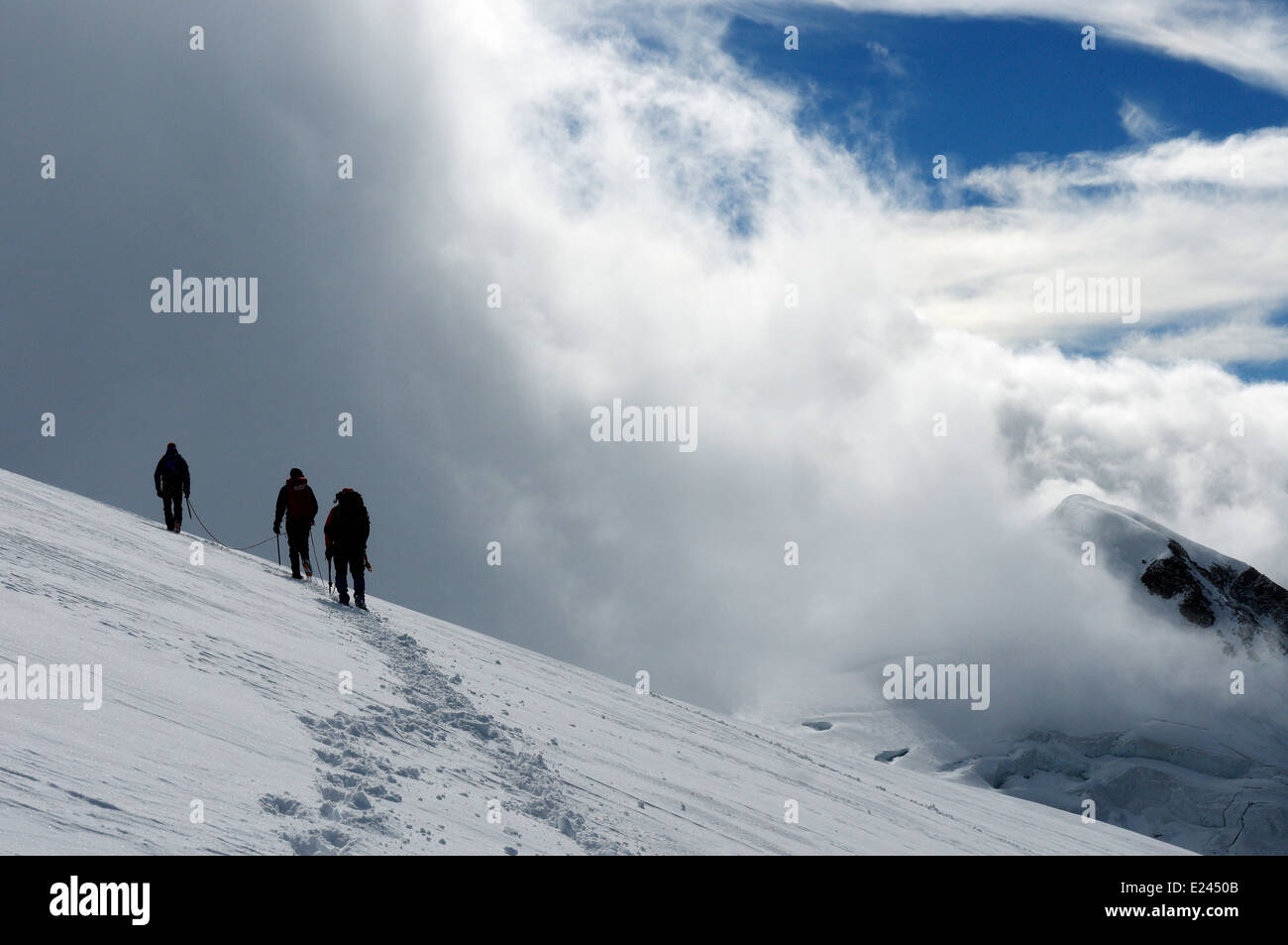 Three mountaineers on Monte Rosa in the Alps Stock Photo