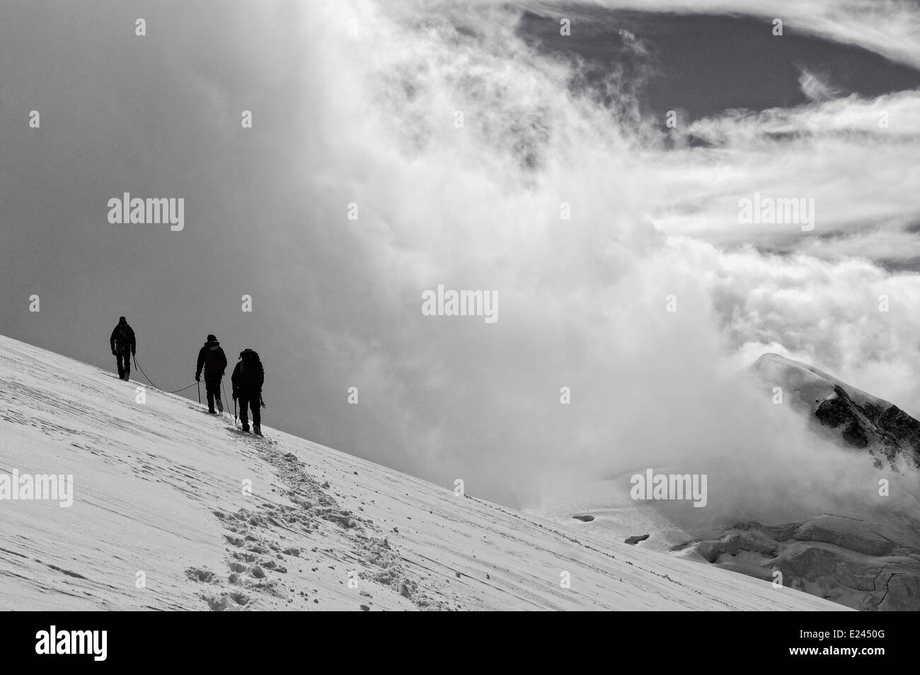 Three mountaineers on Monte Rosa in the Alps Stock Photo