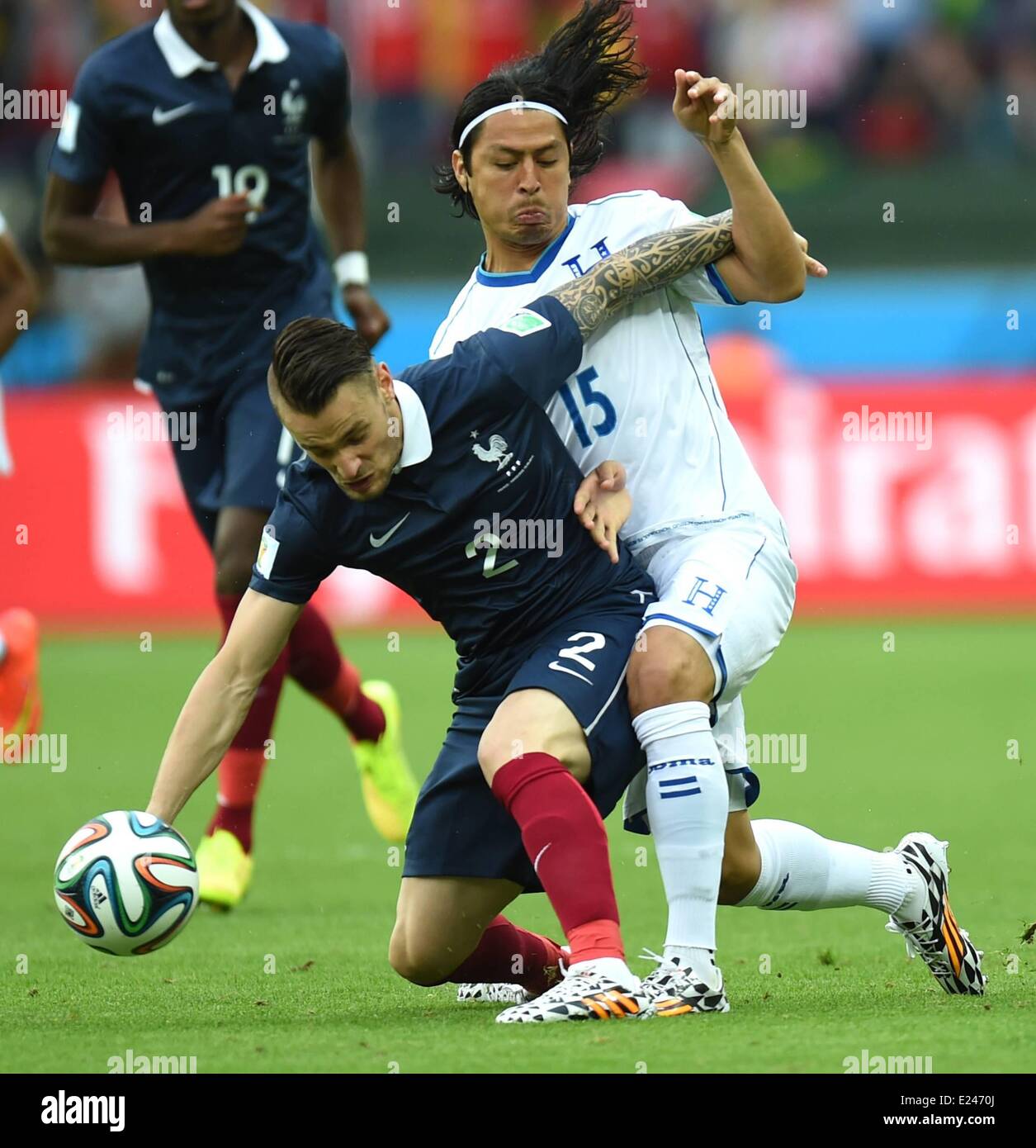 Porto Alegre, Brazil. 15th June, 2014. Frances Mathieu Debuchy (L) challenges with Honduran Roger Espinoza during a Group E match between France and Honduras of 2014 FIFA World Cup at the Estadio Beira-Rio Stadium in Porto Alegre, Brazil, June 15, 2014. Credit:  Action Plus Sports/Alamy Live News Stock Photo
