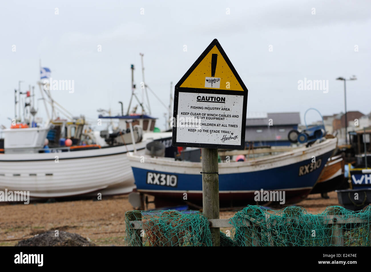 A warning sign by fishing boats in Hastings warning people to take care in a Fishing Industry Area. Hastings, Sussex, UK. 0 Stock Photo