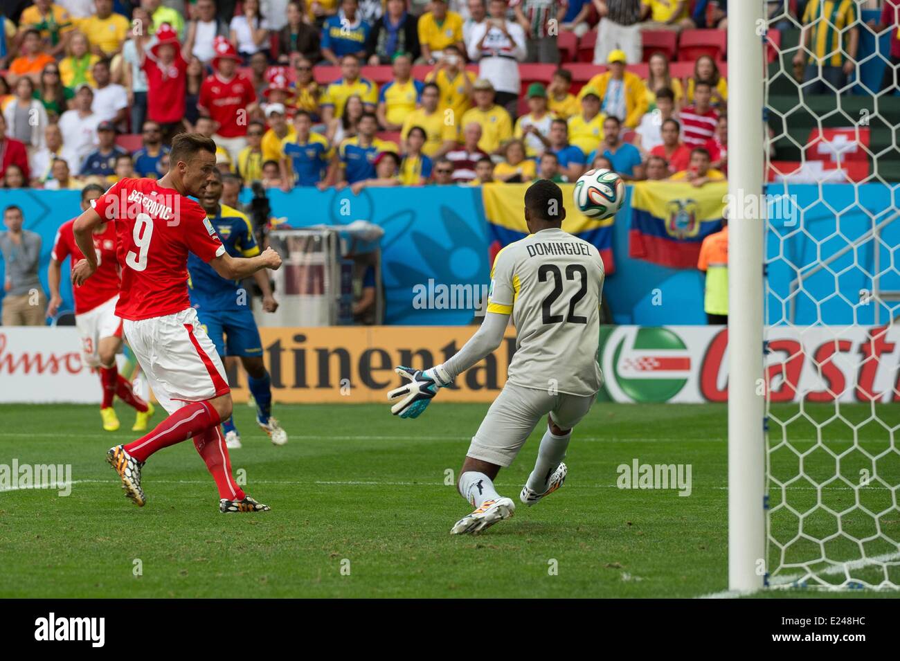 Brasilia, Brazil. 15th June, 2014. Haris Seferovic (SUI) scores past Alexander Dominguez (ECU) fpr the winning goal and 2:1 during a Group E match between Switzerland and Ecuador of 2014 FIFA World Cup at the Estadio Nacional Stadium in Brasilia, capital of Brazil, June 15, 2014. Switzerland won 2-1 over Ecuador on Sunday. Credit:  Action Plus Sports Images/Alamy Live News Stock Photo