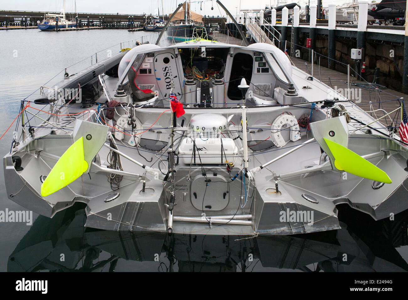 Hugo Boss, an IMOCA 60 short handed racing boat designed to sail in ocean  racing on the dock at Newport Shipyard having repairs Stock Photo - Alamy