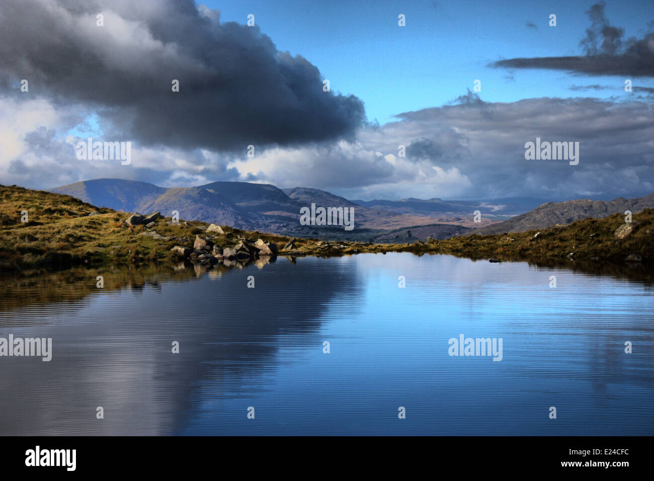 cadair idris mountain range in snowdonia reflected on the surface of a lake Stock Photo