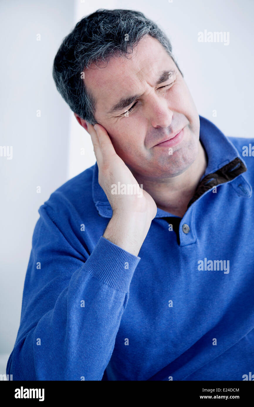 Ear pain in a man Stock Photo