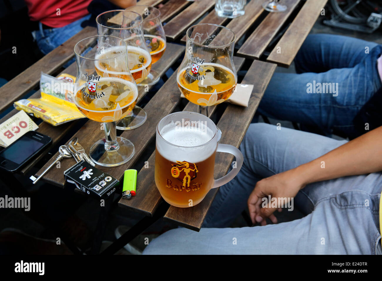 Young people drinking beers in a bar Stock Photo