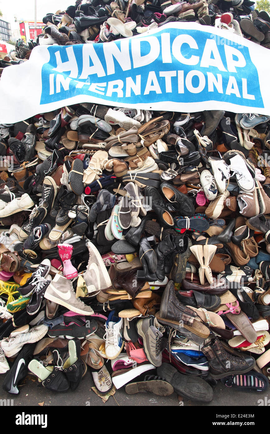 NGO Handicap International. Banner and shoes. Symbolization of landmines injuries. Stock Photo