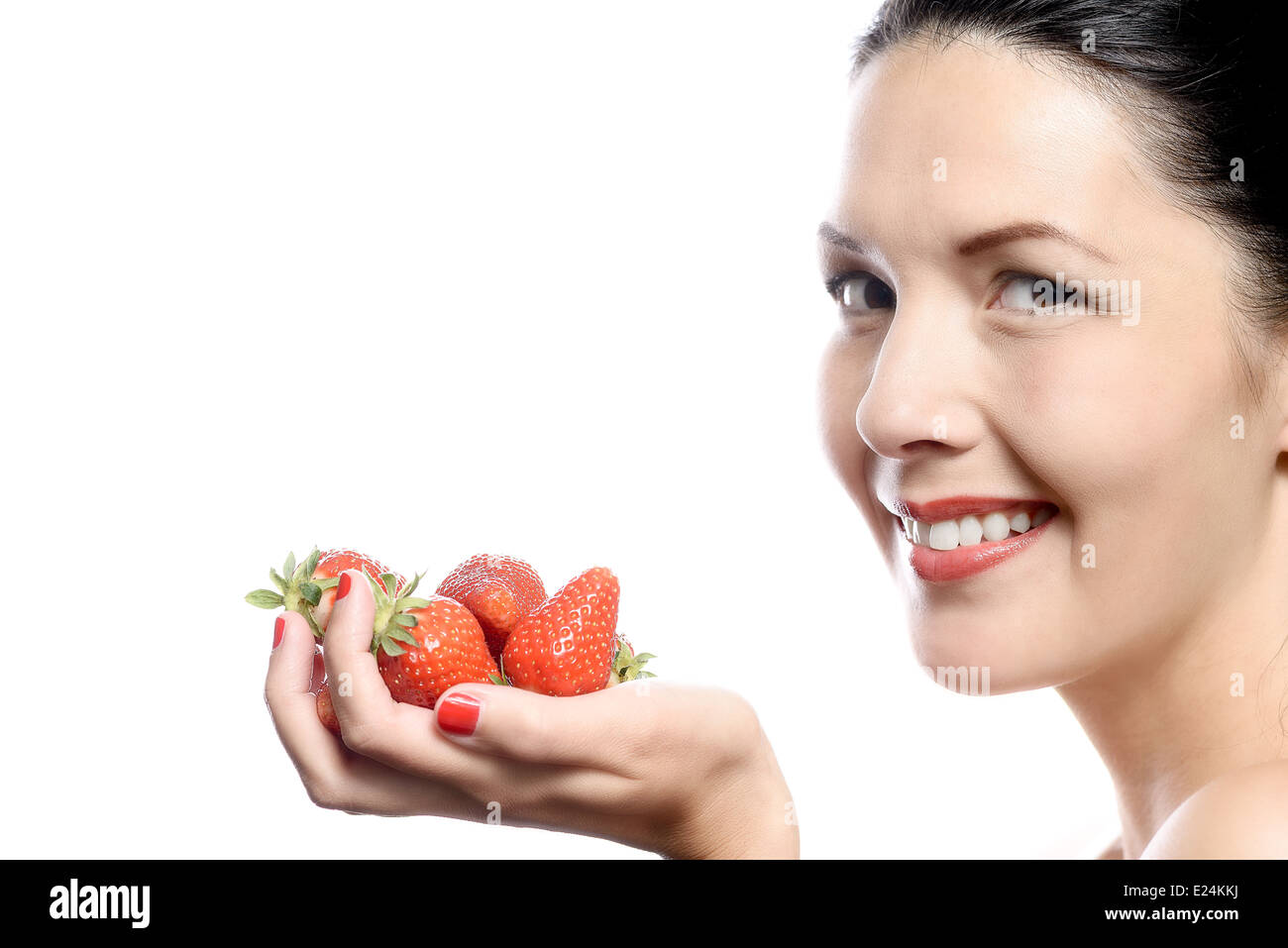Smiling Woman with Strawberries in her Hand on white background. Stock Photo