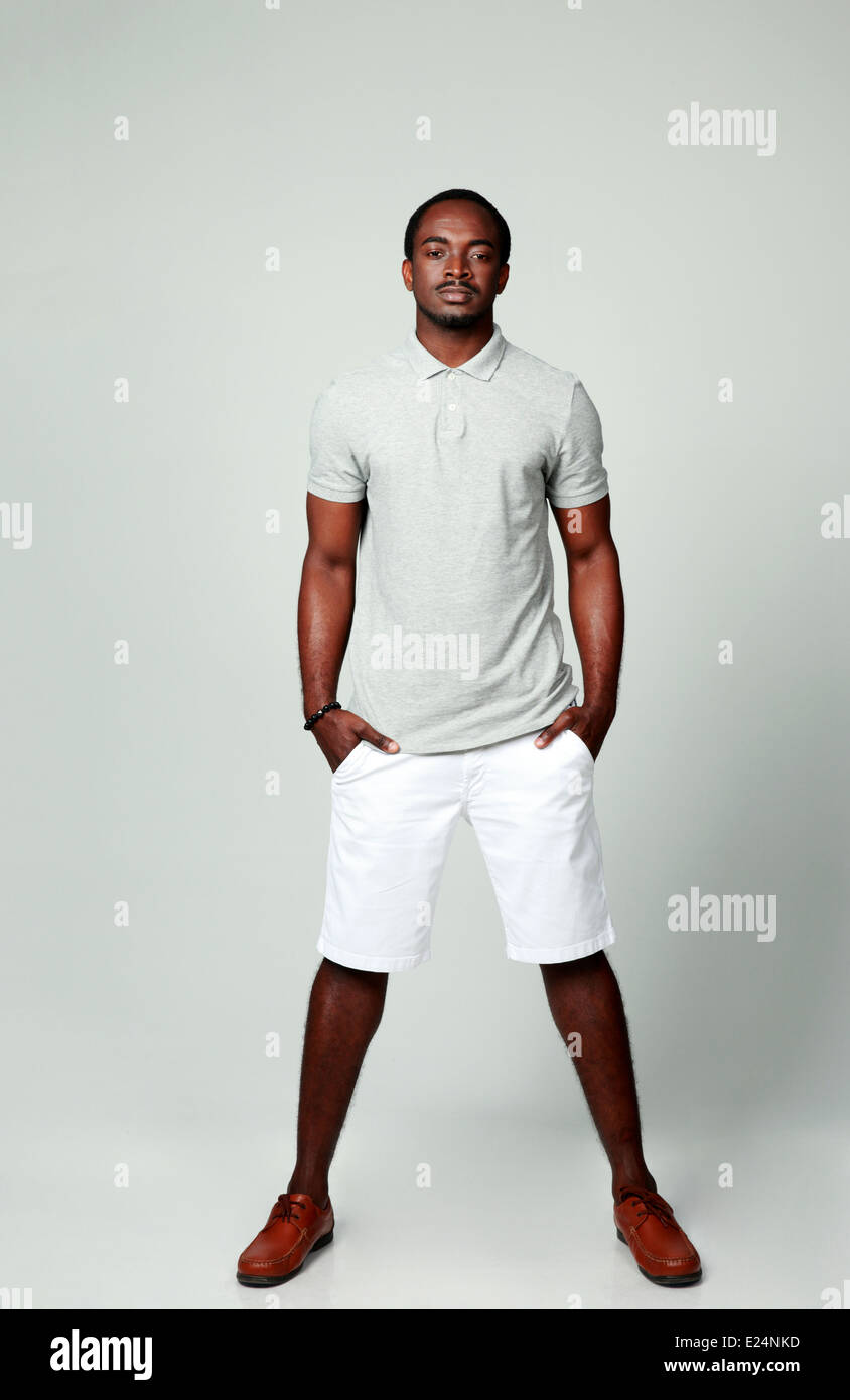 Full length portrait of a pensive african man on gray background Stock ...