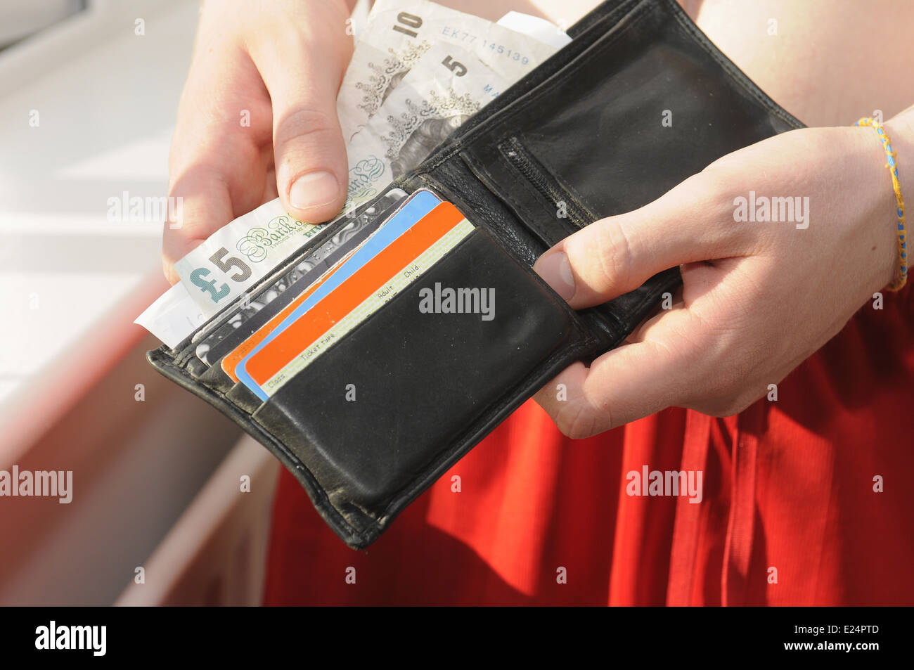 Louis Vuitton wallet filled with cash Stock Photo - Alamy