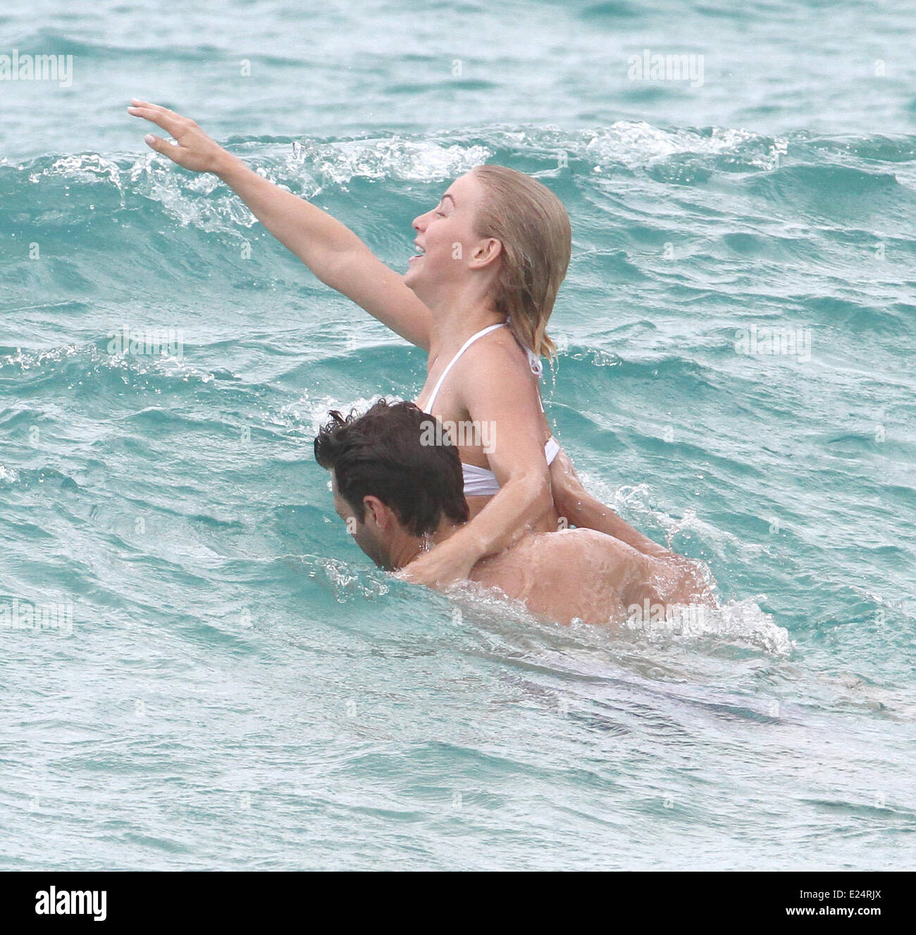 Ryan Seacrest and Julianne Hough were spotted on the beach in the waves in  St.Barts. Showing off her dancer's physique to its fullest extent, Julianne  rocked a white bikini for the outing,