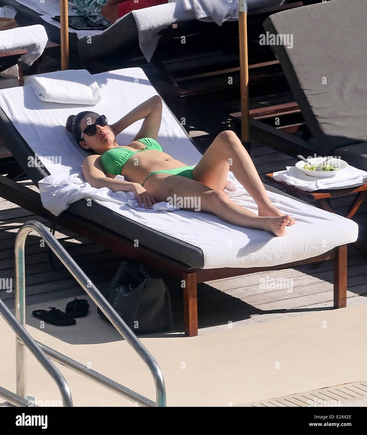 Kelly Brook seen in a green bikini sunbathing  by the pool  Featuring: Kelly Brook Where: Miami, Florida, United States When: 01 Feb 2013 Stock Photo