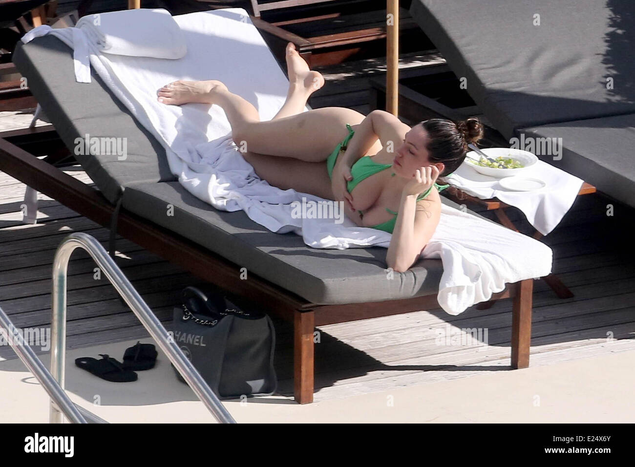 Kelly Brook seen in a green bikini sunbathing  by the pool  Featuring: Kelly Brook Where: Miami, Florida, United States When: 01 Feb 2013 Stock Photo