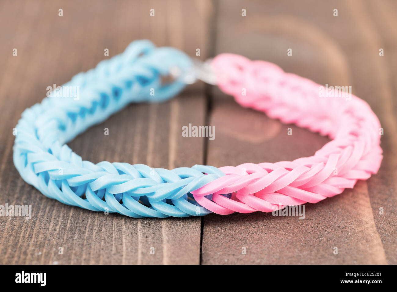 Two color rubber bracelet over a wooden background Stock Photo