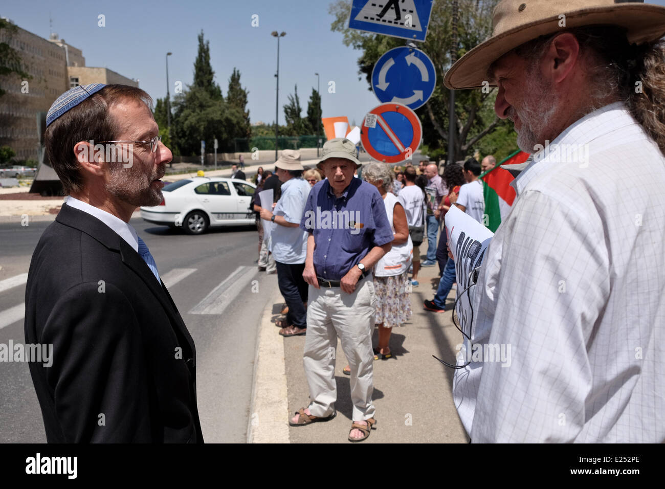 Jerusalem, Israel. 16th June, 2014. MK MOSHE FEIGLIN (Likud Yisrael Beitenu) requests protesters take down the Palestinian flag which harms their humanitarian cause turning it into a political one. Physicians for Human Rights (PHR Israel) staged a demonstration opposite the Knesset protesting government backed legislation underway to allow rapid force feeding of hunger striking Palestinians prisoners. PHR claim some 80 prisoners are hospitalized handcuffed to their beds in Israeli hospitals after more than 50 days of a hunger strike. Credit:  Nir Alon/Alamy Live News Stock Photo