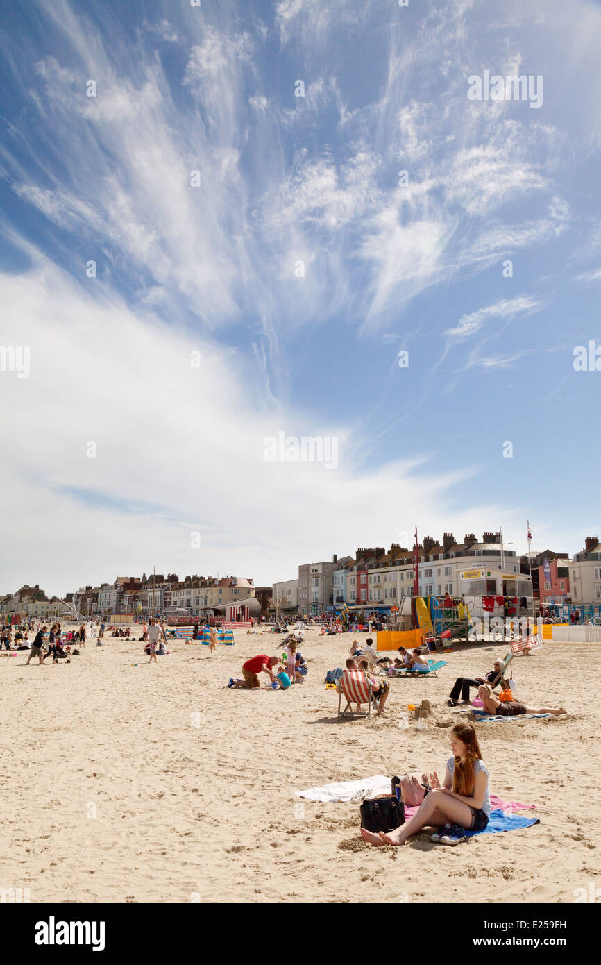 People sunbathing on Weymouth beach, in summer sunshine, Weymouth, Dorset England UK Stock Photo