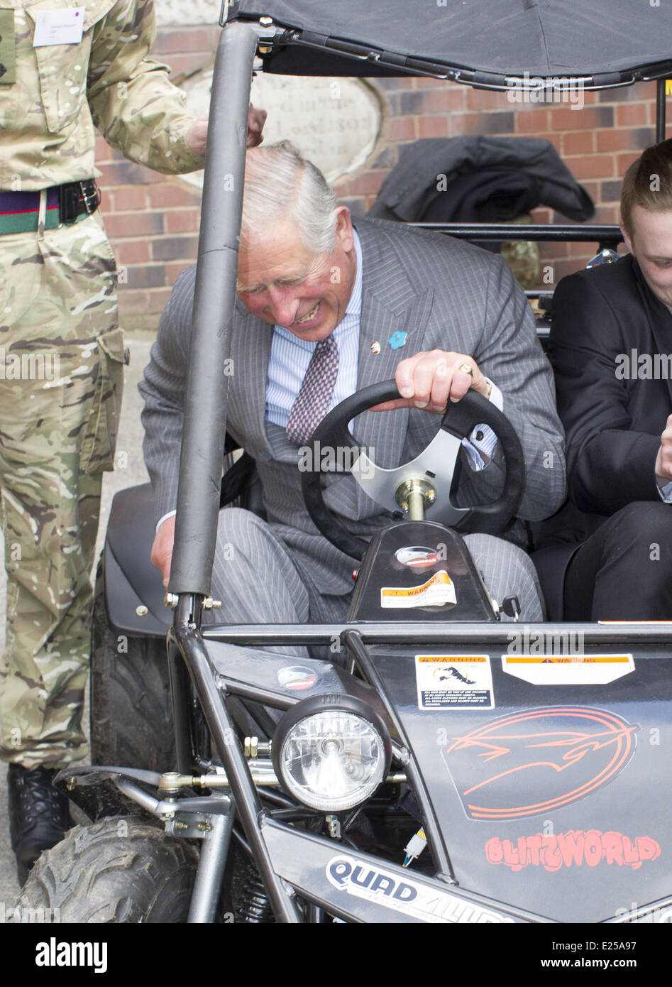 Britain's Prince Charles, HRH The Prince of Wales,   gets into and goes for a drive in a buggy with buggy builder Harley Barker during a visit the Wedgwood Institute where he met local artists who make up Burslem's 'Creative Quarter', viewed Swan Square and then toured Swan Bank Church, Burslem  Featuring: Prince Charles,HRH The Prince of Wales Where: Stoke on Trent, United Kingdom When: 16 May 2013 Stock Photo