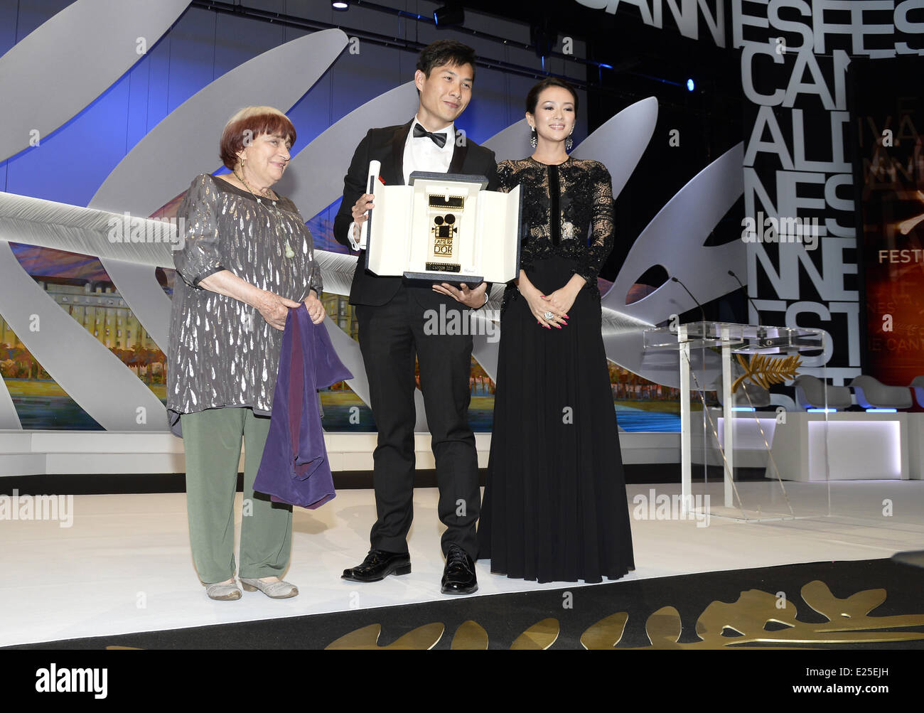 Singaporean director Anthony Chen (C) speaks on stage  surrounded by French director and President of the Camera d'Or Jury Agnes Varda (L) and Chinese actress and member of the Un Certain Regard Jury Zhang Ziyi (R) after winning the Camera d'Or for Best First Film at the 66th Cannes film festival in Cannes.  Featuring: Agnes Varda,Anthony Chen,Zhang Ziyi Where: Cannes, France When: 26 May 2013 Stock Photo