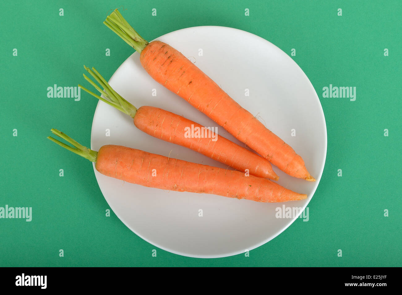 Three Raw Uncooked Carrots providing 100 Calories Stock Photo